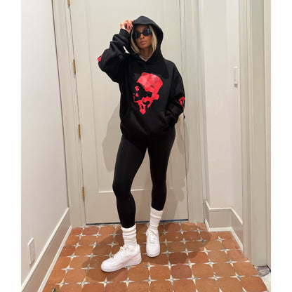 Ciara wearing The CiCi Hoodie. Black hoodie with red graphic design