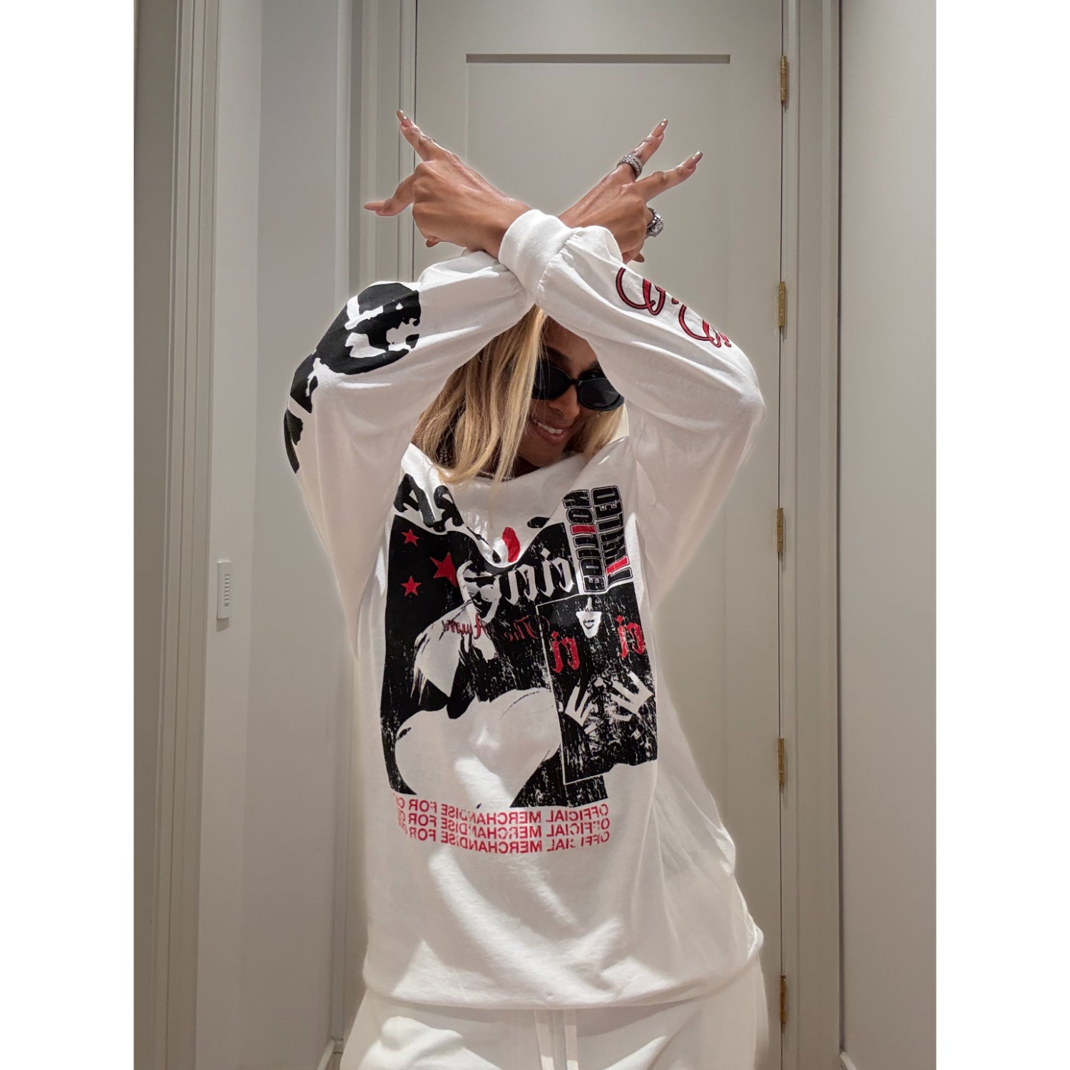 Ciara wearing the limited edition long-sleeve tee in white